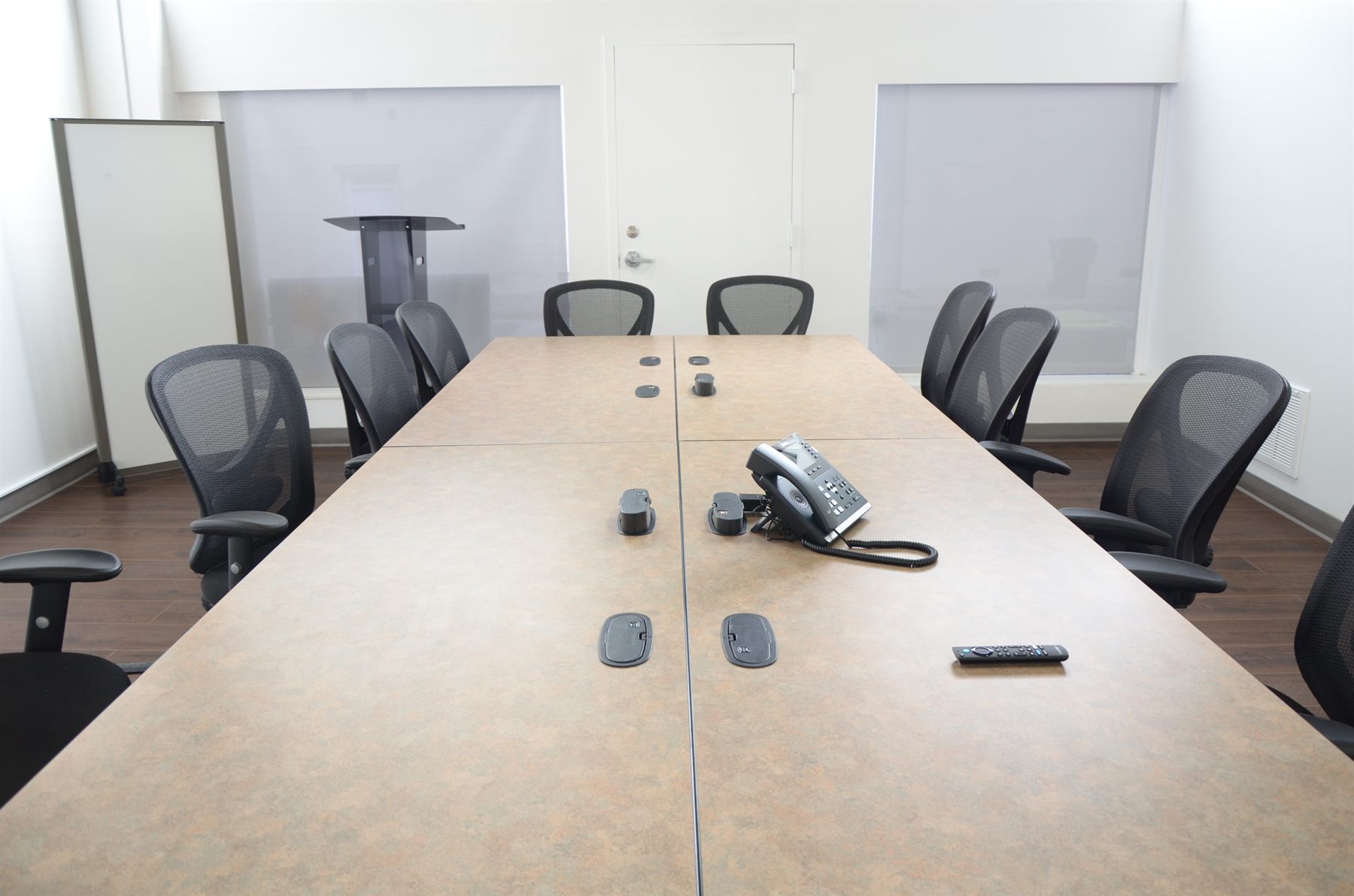 Conference room with long table and TV